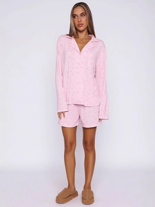 Pink long sleeve pajama set with heart patterns and matching shorts for home wear