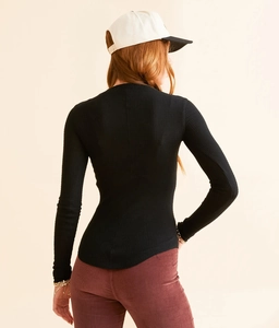 Rear view of tight-fit black long-sleeve top in premium fine ribbed knit fabric
