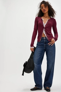 Full view of a wine red waffle knit cardigan paired with wide-leg high-waisted jeans