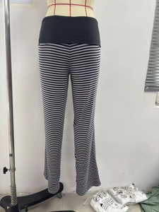Detail of high waisted striped flare pants with elastic waistband on a mannequin