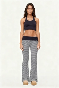 Detail of high waisted black and white striped flare pants with a matching halter sports top