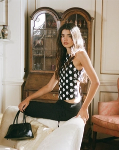 Detail view of polka dot halter top with side ties and elegant open back design