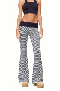 Detail of high-waisted black and white striped flare pants with elastic waistband