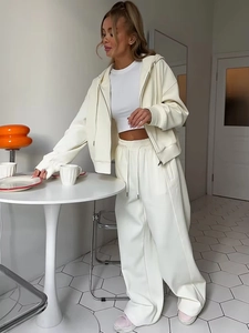 Detail of off-white three-piece lounge set with drawstring hoodie and wide-leg joggers