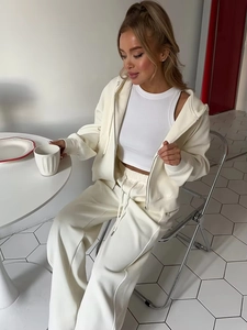 Detail view of cream white hooded tracksuit set featuring a zip-up hoodie and drawstring pants