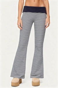 Detail of high-waist striped flared trousers with contrast waistband and slim fit cut