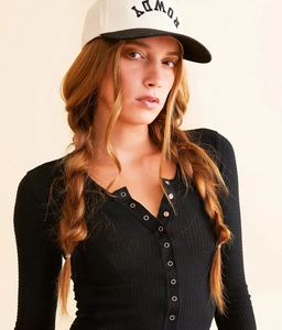 Close-up of black waffle knit long sleeve henley top with metal buttons and rowdy cap