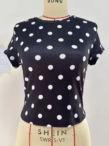 Detailed view of women's slim fit black short sleeve t-shirt with white polka dot print
