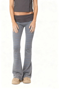 Detail of high-waist striped flared trousers with slimming fit and patchwork waistband
