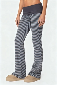 Detail shot of women's striped flared trousers featuring a high waist fold-over band design