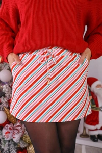 Detail of Christmas striped mini skirt with adjustable drawstring and gold metal tips
