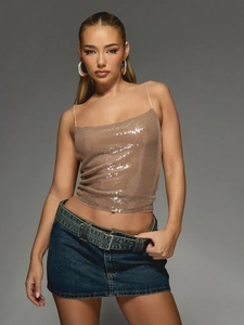 Sparkly champagne sequin camisole top paired with denim skirt for party clubwear