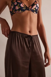Detail view of floral lace bra top and premium satin trousers with elastic drawstring waist