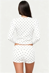 Detailed back view of two-piece loungewear set featuring chic black polka dot patterns