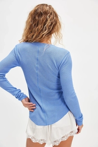 Back view of slim fit blue waffle knit cardigan with curved hem and long sleeves