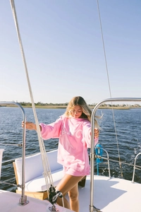 Pink long sleeve sweatshirt and shorts set with white letter print in a sunny outdoor setting