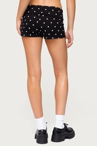 Detailed back view of women's black polka dot shorts with high-waisted folded design