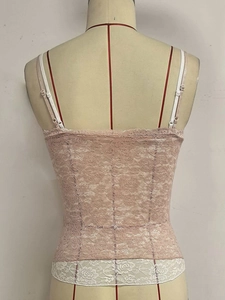 Close-up of pink lace camisole showing floral texture and adjustable thin straps