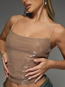 Close-up of champagne gold sequin crop top featuring delicate straps and metallic shimmer