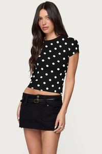 Close-up of black slim fit crop top with white polka dot pattern and cargo skirt