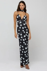 Detail of slim strap polka dot dress featuring a deep V-neck and matching choker accessory
