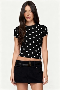 Detail of vintage black and white polka dot crop top with slim fit and round neck