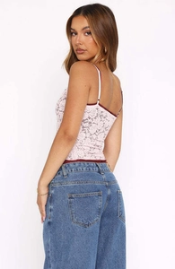 Detail of pink floral lace camisole top with adjustable spaghetti straps and slim fit
