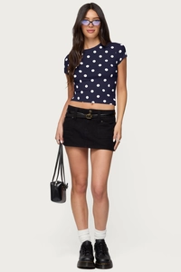 Detail of retro polka dot t-shirt and denim mini skirt with belt and loafers