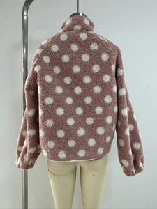 Close-up of the back view of pink fleece jacket with white polka dots and stand collar