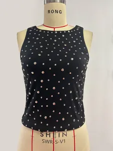 Close-up detail of silver metallic studs on black sleeveless slim fit tank top for women