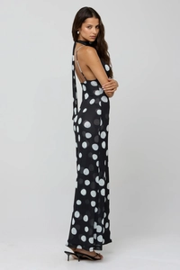 Detailed view of backless halter dress featuring black and white polka dot pattern print