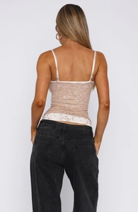 Back view of a lace camisole showing slim straps and metal adjustment buckles