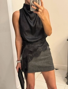 Detail of cowl neck satin top and herringbone mini skirt with asymmetric lace hem