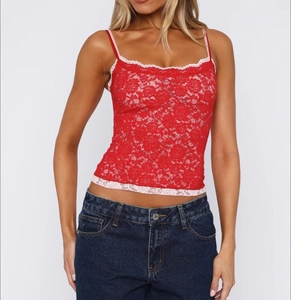 Close-up of red lace camisole top featuring pink floral trim and slim fit design