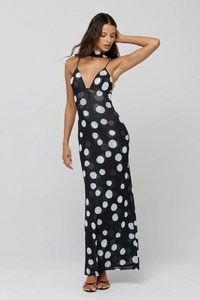 Detailed view of sexy backless black dress with white polka dots and halter neck
