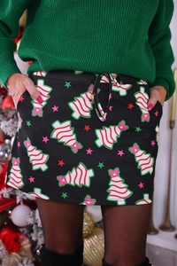Detail of Christmas A-line skirt with festive tree prints, drawstring waist and side pockets