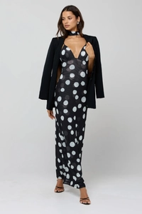 Detail of polka dot maxi dress with matching neck strap and black blazer set