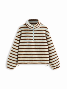 Detail of sherpa fleece texture with blue and brown stripes and a half-zip high collar