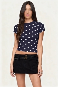 Close-up of a slim fit navy blue polka dot crop top with a stylish crew neck for women
