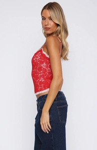 Close-up of red floral lace camisole top with pink scalloped trim and delicate texture