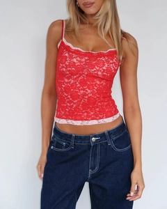 Detail of red floral lace camisole with pink trim and blue denim jeans contrast stitching