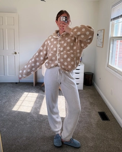 Close-up of beige polka dot fleece jacket with snap buttons and waffle knit joggers