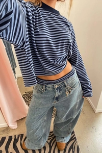 Macro shot of striped long sleeve crew neck top with light blue wide leg denim pants