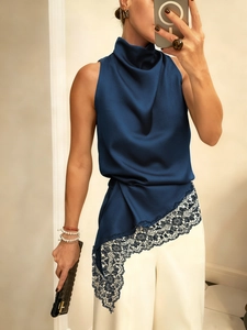 Detailed view of dark blue satin halter top with elegant lace trim and asymmetric hem