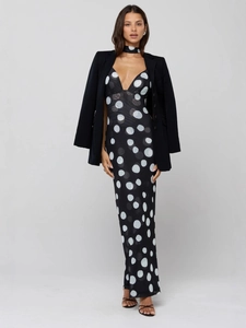 Polka dot maxi dress with deep V-neck paired with a black blazer for a chic look