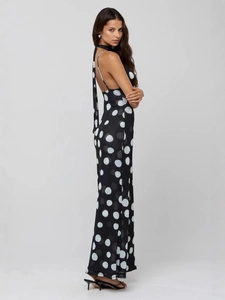 Elegant backless black dress with white polka dots featuring a slim fit and ankle-length cut