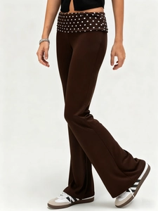 Women's slim flared trousers in dark brown with polka dot fold-over waistband design