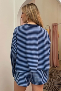 Rear view of striped loungewear set with long sleeve top and relaxed shorts