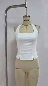 Detail of white halter neck top featuring symmetric hem slits and slim fit ribbed knit texture