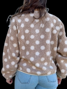 Detail of soft khaki fleece jacket with white polka dots and premium hem finishing